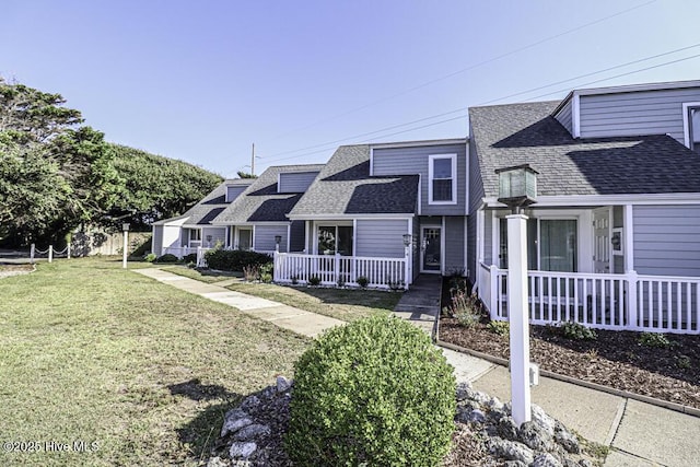 130 Salter Path Rd Unit 74, Pine Knoll Shores, NC 28512 - view of front of house with a shingled roof, covered porch, and a front lawn