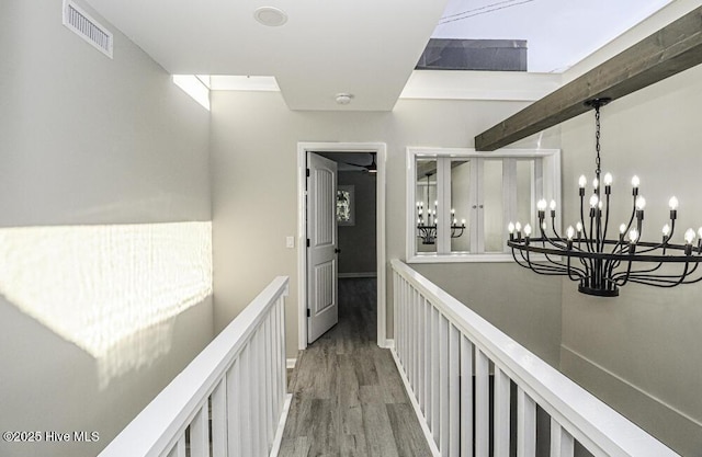 130 Salter Path Rd Unit 74, Pine Knoll Shores, NC 28512 - hall with light wood-style floors, an upstairs landing, a chandelier, and beamed ceiling