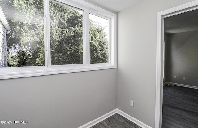 130 Salter Path Rd Unit 74, Pine Knoll Shores, NC 28512 - empty room with baseboards and dark wood-type flooring