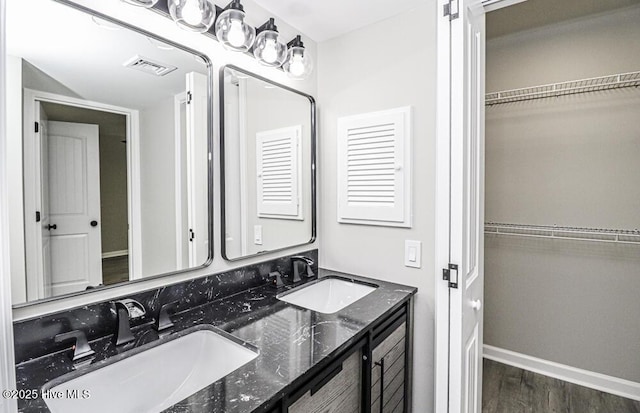 130 Salter Path Rd Unit 74, Pine Knoll Shores, NC 28512 - bathroom featuring double vanity, wood finished floors, and a spacious closet