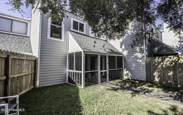 130 Salter Path Rd Unit 74, Pine Knoll Shores, NC 28512 - back of property featuring a sunroom, roof with shingles, and a fenced backyard