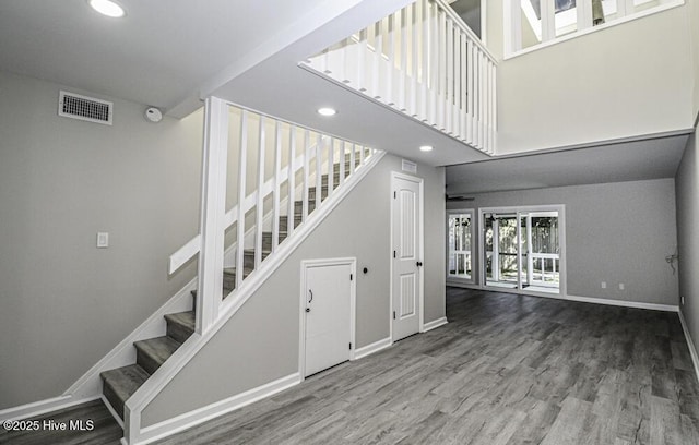 130 Salter Path Rd Unit 74, Pine Knoll Shores, NC 28512 - stairs with wood finished floors, recessed lighting, and a high ceiling