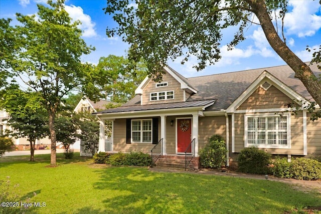 208 Smith Dr, Goldsboro, NC 27534 - view of front of home with a front lawn, a standing seam roof, a shingled roof, and a metal roof