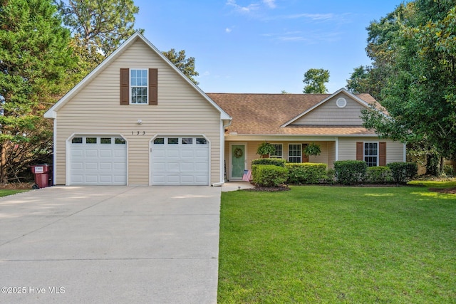133 Graystone Rd, Wilmington, NC 28411 - traditional home featuring concrete driveway, a front yard, a garage, and roof with shingles