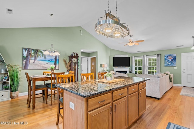 133 Graystone Rd, Wilmington, NC 28411 - kitchen featuring ceiling fan, light wood-type flooring, a chandelier, a kitchen island, and high vaulted ceiling