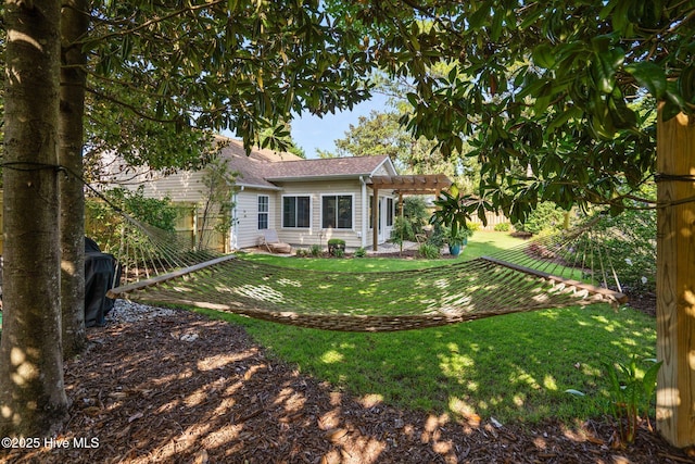 133 Graystone Rd, Wilmington, NC 28411 - back of house with a pergola, a lawn, and roof with shingles