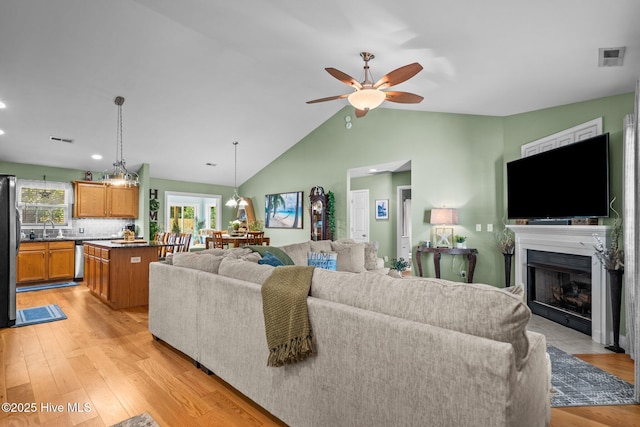 133 Graystone Rd, Wilmington, NC 28411 - living area with a ceiling fan, a fireplace with flush hearth, light wood-type flooring, lofted ceiling, and recessed lighting