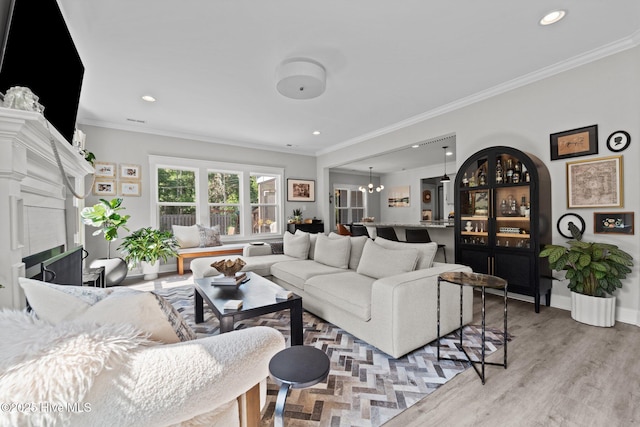 3 Glen Ross Dr, Pinehurst, NC 28374 - living area featuring crown molding, light wood-style flooring, recessed lighting, a chandelier, and a fireplace