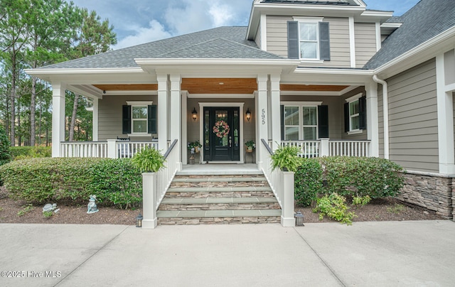 595 Wicklow Sq SW, Ocean Isle Beach, NC 28469 - property entrance with covered porch and a shingled roof