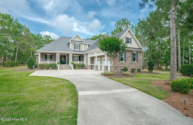 595 Wicklow Sq SW, Ocean Isle Beach, NC 28469 - craftsman-style house with a porch, a standing seam roof, an attached garage, stone siding, and driveway