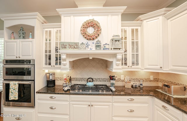 595 Wicklow Sq SW, Ocean Isle Beach, NC 28469 - kitchen featuring stainless steel appliances, tasteful backsplash, dark stone counters, and crown molding