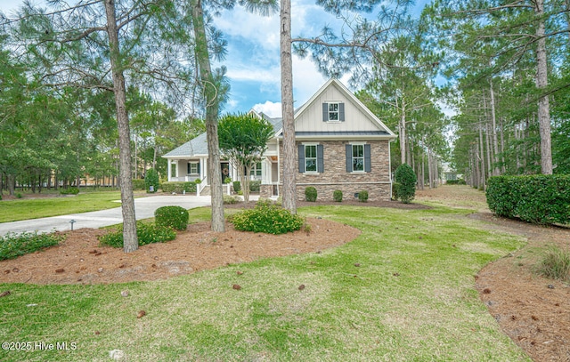 595 Wicklow Sq SW, Ocean Isle Beach, NC 28469 - craftsman house featuring a front yard, concrete driveway, stone siding, and board and batten siding
