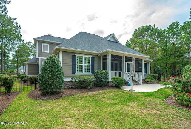 595 Wicklow Sq SW, Ocean Isle Beach, NC 28469 - view of front of house featuring a sunroom, a patio, and roof with shingles