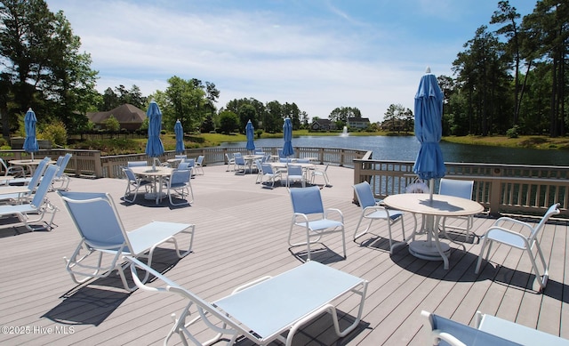 595 Wicklow Sq SW, Ocean Isle Beach, NC 28469 - deck featuring outdoor dining space, a water view, and view of scattered trees