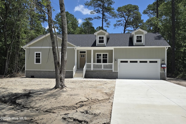 904 Nautillus Ct, New Bern, NC 28560 - view of front of home featuring an attached garage, covered porch, concrete driveway, and a shingled roof