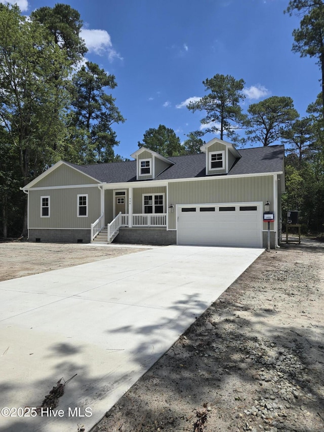 904 Nautillus Ct, New Bern, NC 28560 - view of front of home featuring a garage, covered porch, driveway, roof with shingles, and crawl space