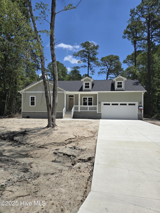 904 Nautillus Ct, New Bern, NC 28560 - view of front of house featuring a porch, an attached garage, concrete driveway, roof with shingles, and crawl space