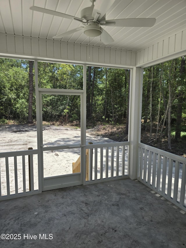 904 Nautillus Ct, New Bern, NC 28560 - unfurnished sunroom with a ceiling fan and view of scattered trees