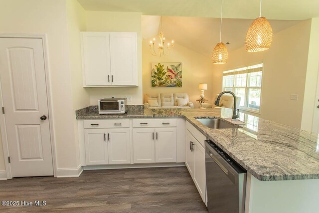 430 Boundaryline Dr NW, Calabash, NC 28467 - kitchen with stainless steel dishwasher, dark wood-style flooring, a peninsula, white cabinetry, and light stone counters