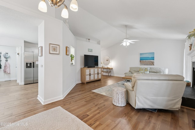 103 Coppers Trl, Wilmington, NC 28411 - living room featuring lofted ceiling, light wood-style flooring, ceiling fan, and a fireplace