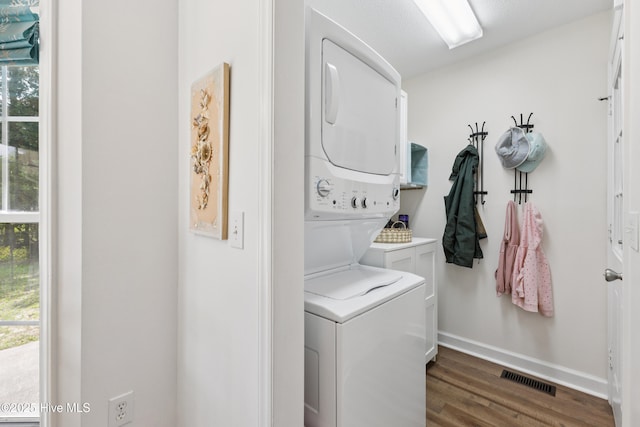 103 Coppers Trl, Wilmington, NC 28411 - washroom featuring stacked washer / drying machine, cabinet space, and wood finished floors