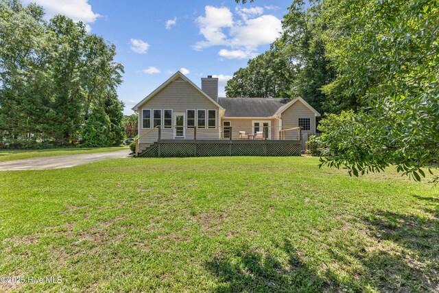 103 Coppers Trl, Wilmington, NC 28411 - view of front facade with a chimney, a deck, and a front yard