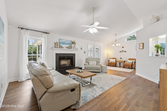 103 Coppers Trl, Wilmington, NC 28411 - living area with wood finished floors, vaulted ceiling, ceiling fan, a fireplace, and a chandelier