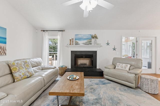 103 Coppers Trl, Wilmington, NC 28411 - living area featuring wood finished floors, ceiling fan, a fireplace with raised hearth, and radiator heating unit