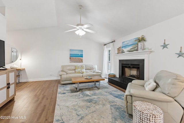 103 Coppers Trl, Wilmington, NC 28411 - living room with lofted ceiling, wood finished floors, a ceiling fan, and a fireplace with raised hearth