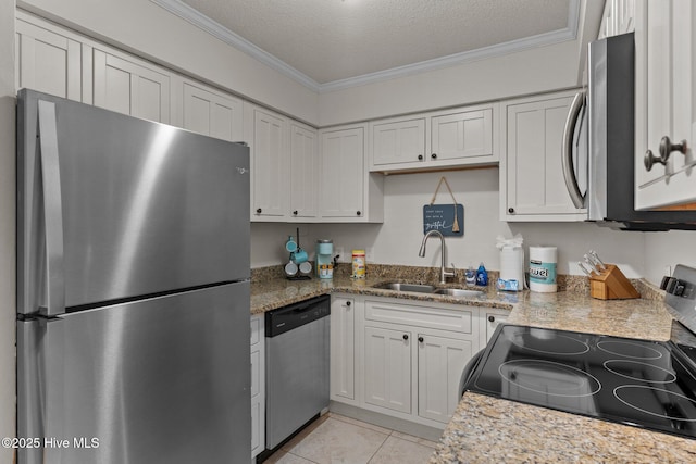 1004 Carolina Beach Ave S Unit B6, Carolina Beach, NC 28428 - kitchen featuring stainless steel appliances, crown molding, light tile patterned floors, a textured ceiling, and light stone counters