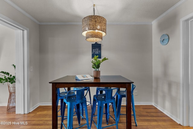 1004 Carolina Beach Ave S Unit B6, Carolina Beach, NC 28428 - dining room with wood finished floors, crown molding, a chandelier, and a textured ceiling