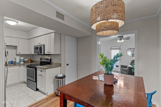 1004 Carolina Beach Ave S Unit B6, Carolina Beach, NC 28428 - kitchen with stainless steel appliances, white cabinetry, ornamental molding, a ceiling fan, and light wood finished floors