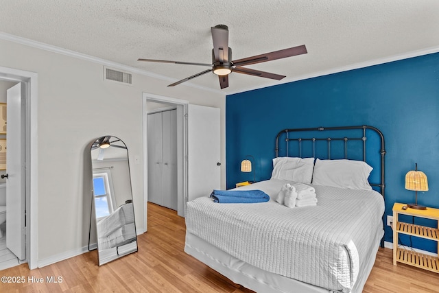 1004 Carolina Beach Ave S Unit B6, Carolina Beach, NC 28428 - bedroom with ornamental molding, wood finished floors, a textured ceiling, and ceiling fan