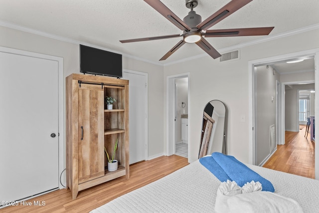 1004 Carolina Beach Ave S Unit B6, Carolina Beach, NC 28428 - bedroom featuring light wood-style flooring, ornamental molding, ensuite bathroom, and a ceiling fan