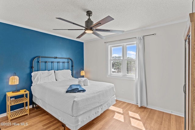 1004 Carolina Beach Ave S Unit B6, Carolina Beach, NC 28428 - bedroom featuring wood finished floors, a textured ceiling, ceiling fan, and crown molding