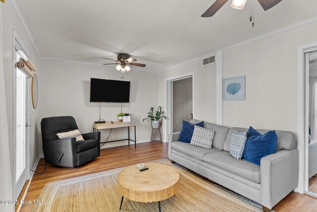 1004 Carolina Beach Ave S Unit B6, Carolina Beach, NC 28428 - living room featuring ceiling fan, crown molding, and light wood-style flooring