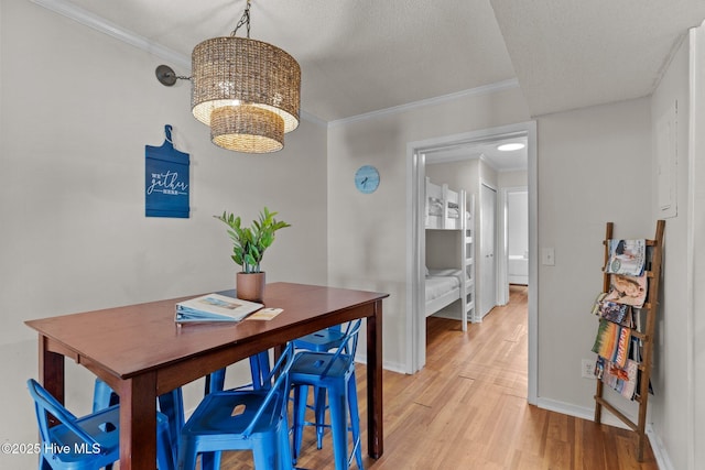 1004 Carolina Beach Ave S Unit B6, Carolina Beach, NC 28428 - dining area with light wood-style flooring, crown molding, a desk, and a chandelier