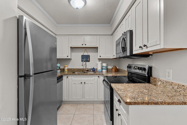 1004 Carolina Beach Ave S Unit B6, Carolina Beach, NC 28428 - kitchen with stainless steel appliances, a textured ceiling, ornamental molding, white cabinetry, and stone countertops