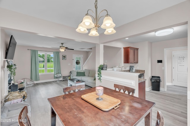 203 Mccain St, Beulaville, NC 28518 - dining room with light wood-style flooring, a chandelier, and a ceiling fan