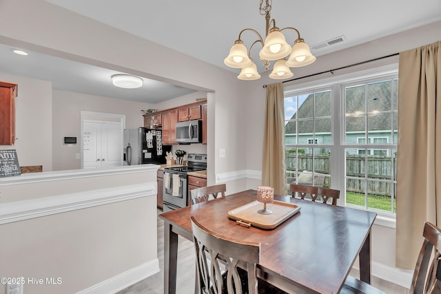 203 Mccain St, Beulaville, NC 28518 - dining area with a chandelier and light wood-style floors