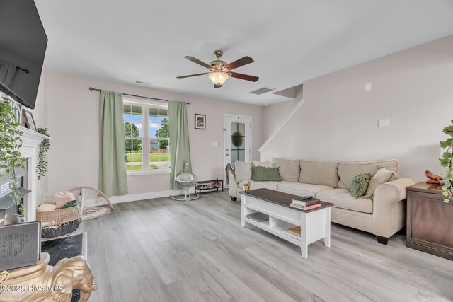 203 Mccain St, Beulaville, NC 28518 - living room with a ceiling fan, light wood-style floors, and a fireplace