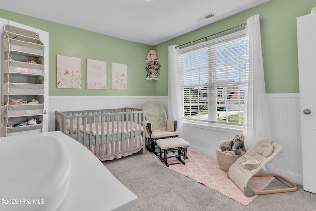 203 Mccain St, Beulaville, NC 28518 - bedroom with a wainscoted wall, carpet flooring, and a crib