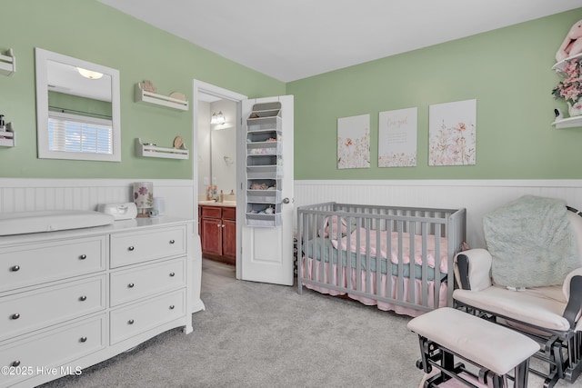 203 Mccain St, Beulaville, NC 28518 - bedroom featuring a wainscoted wall, light carpet, and connected bathroom