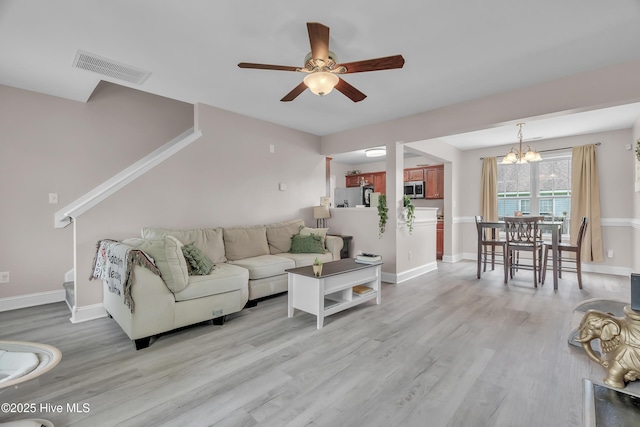 203 Mccain St, Beulaville, NC 28518 - living room with a chandelier, light wood-style floors, and ceiling fan