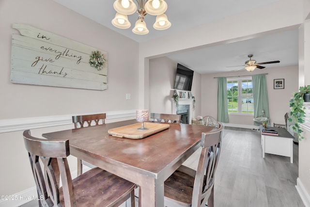 203 Mccain St, Beulaville, NC 28518 - dining space with a chandelier, a fireplace, wood finished floors, and ceiling fan