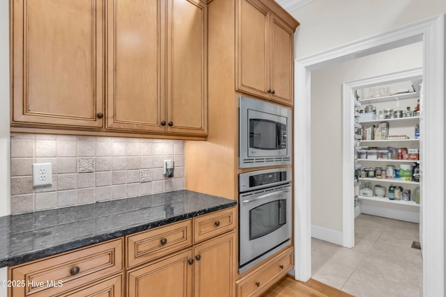 1514 Grandiflora Dr, Leland, NC 28451 - kitchen with appliances with stainless steel finishes, tasteful backsplash, dark stone counters, and light tile patterned flooring