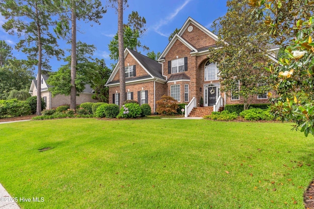 1514 Grandiflora Dr, Leland, NC 28451 - view of front facade with brick siding and a front lawn