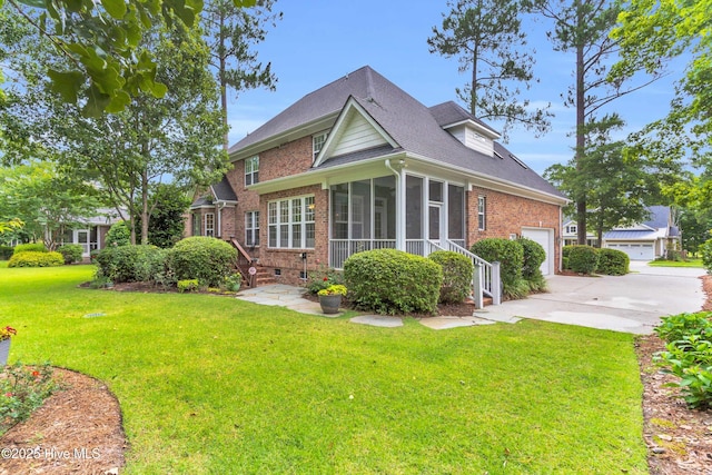 1514 Grandiflora Dr, Leland, NC 28451 - back of house featuring brick siding, a sunroom, driveway, a yard, and an attached garage