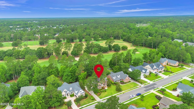 1514 Grandiflora Dr, Leland, NC 28451 - aerial perspective of suburban area with a heavily wooded area and a local golf course