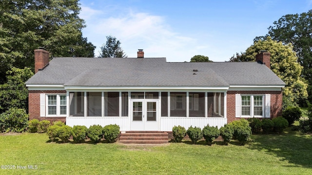 6074 NC-42 Hwy W, Macclesfield, NC 27852 - back of property with a sunroom, a chimney, a lawn, and brick siding